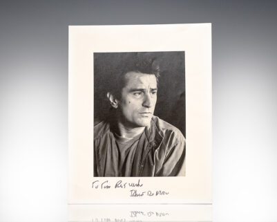 Man looking to the side with a handwritten signature
